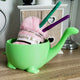 3D printed dinosaur yarn bowl in green showing T-Rex head with open mouth yarn slot
