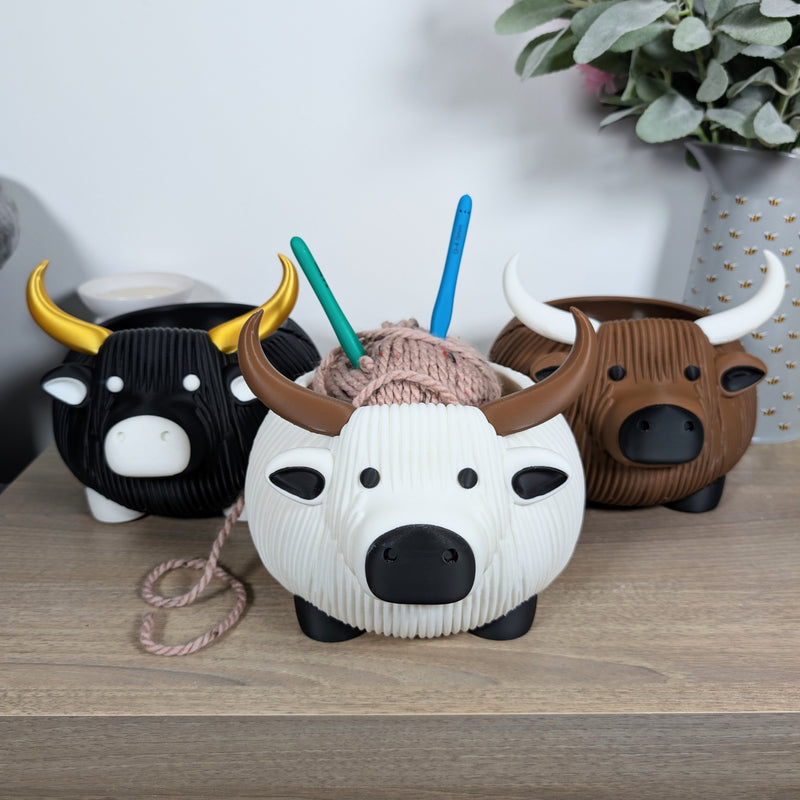 3D printed highland cow yarn bowl in natural colourway with yarn threaded through horns