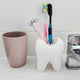 3D printed tooth toothbrush holder in white holding two toothbrushes